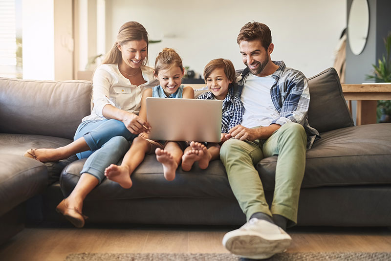 Family sitting around a laptop